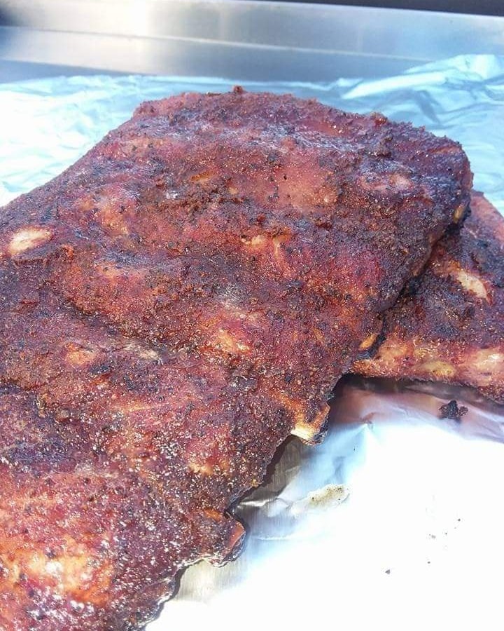 Dry-rubbed smoked ribs resting after a low-and-slow cook