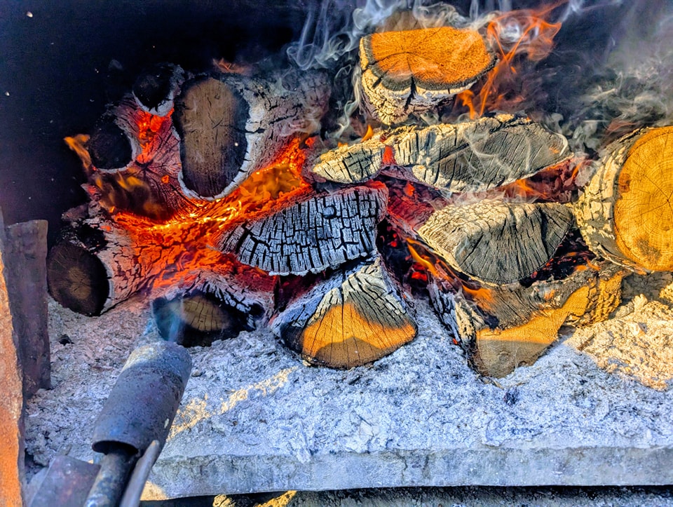 Stacked natural hardwood split and ready for the smoker
